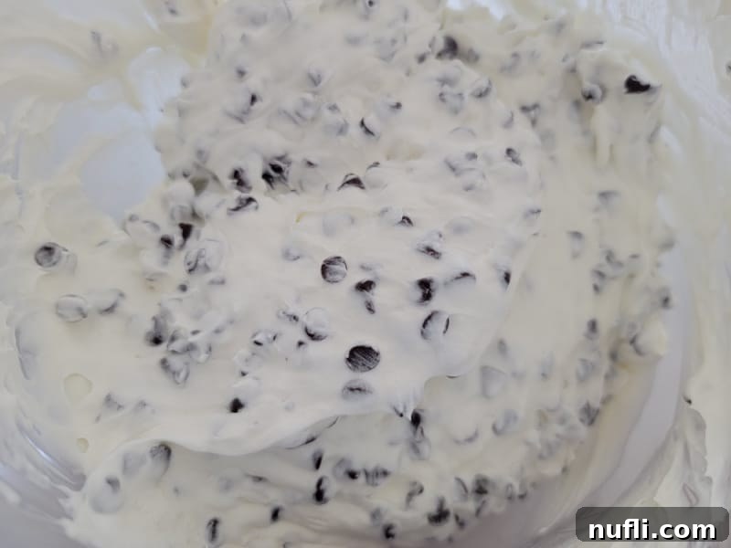 mini chocolate chips in a cream cheese mixture in a glass bowl 