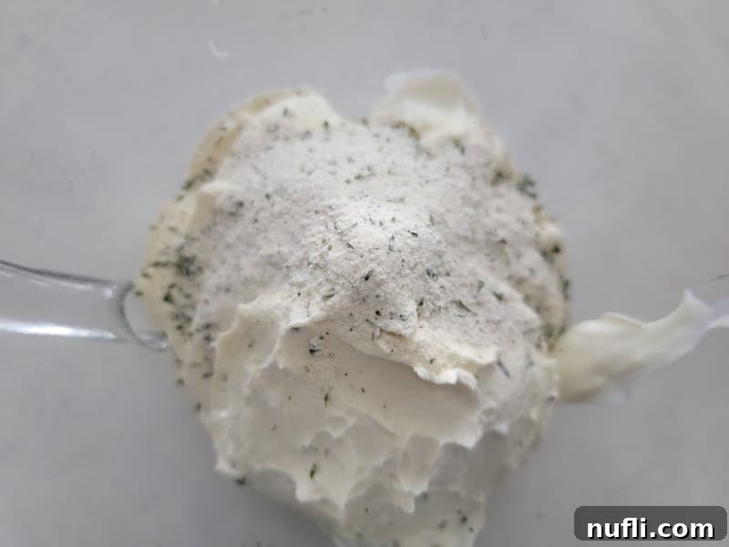 Quick 3-Ingredient Potato Chip Dip 4 ranch dressing mix on sour cream in a glass bowl