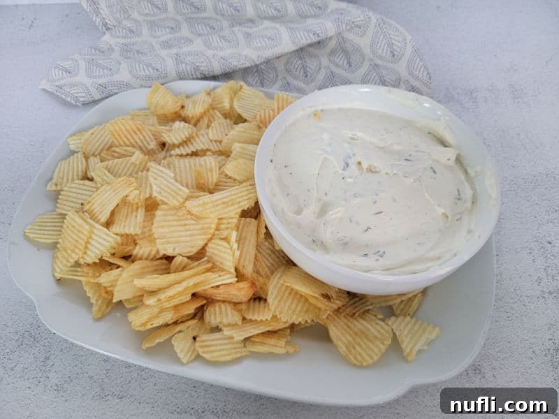 Quick 3-Ingredient Potato Chip Dip 6 White plate with potato chips and a bowl of potato chip dip next to a cloth napkin
