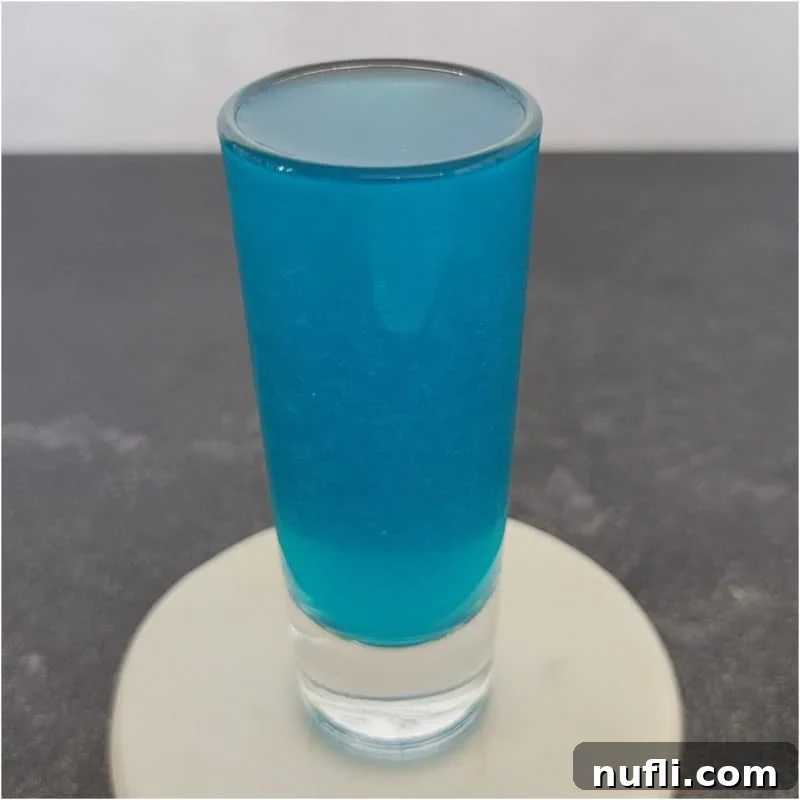 Tropical Malibu Rum Creations 20 Blue cocktail shot on a white coaster.