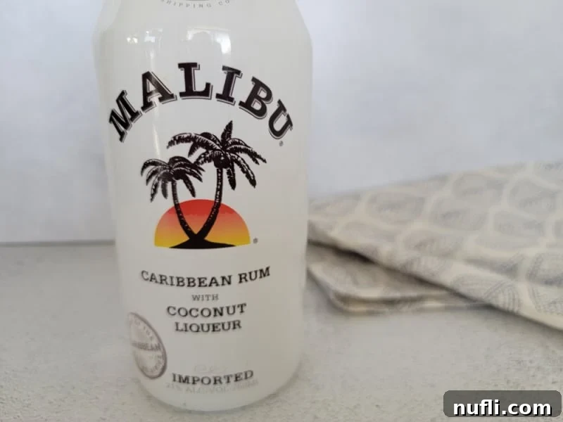 Tropical Malibu Rum Creations 21 Malibu rum bottle next to a cloth napkin