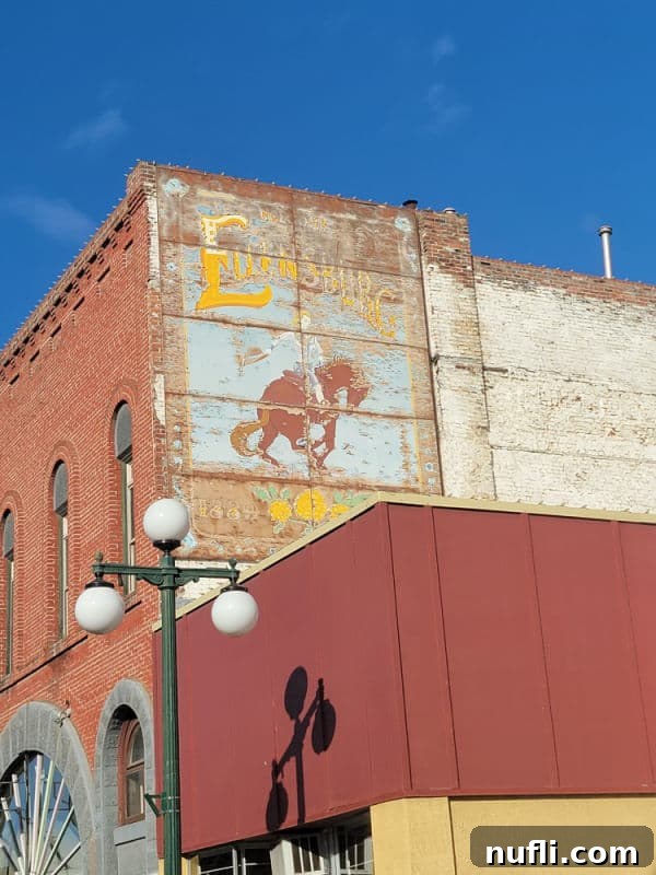 Ellensburg Unveiled: Your Washington Adventure 11 Ellensburg mural with a woman riding a horse on the side of a historic building