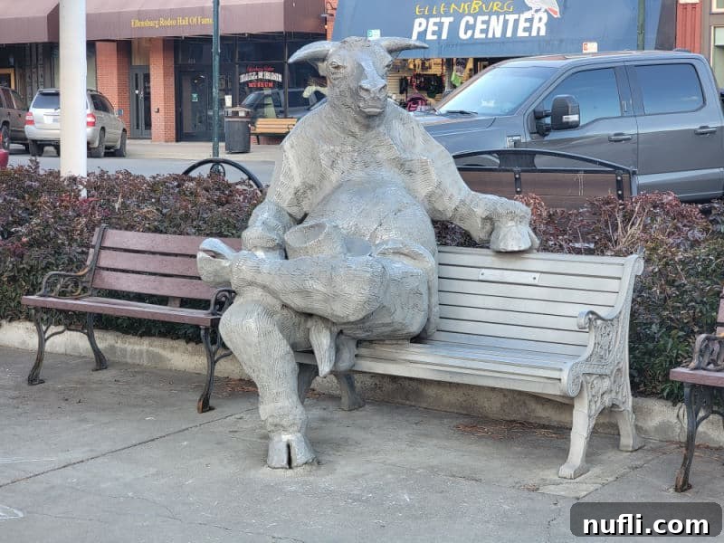 Ellensburg bull statue sitting on a park bench 