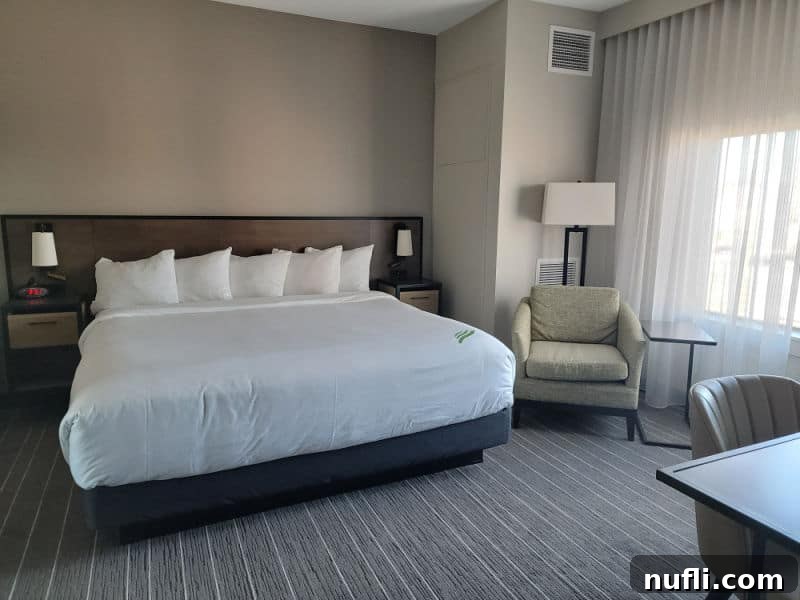 Ellensburg Unveiled: Your Washington Adventure 24 king size bed in the hotel Windrow with a table and chair next to it