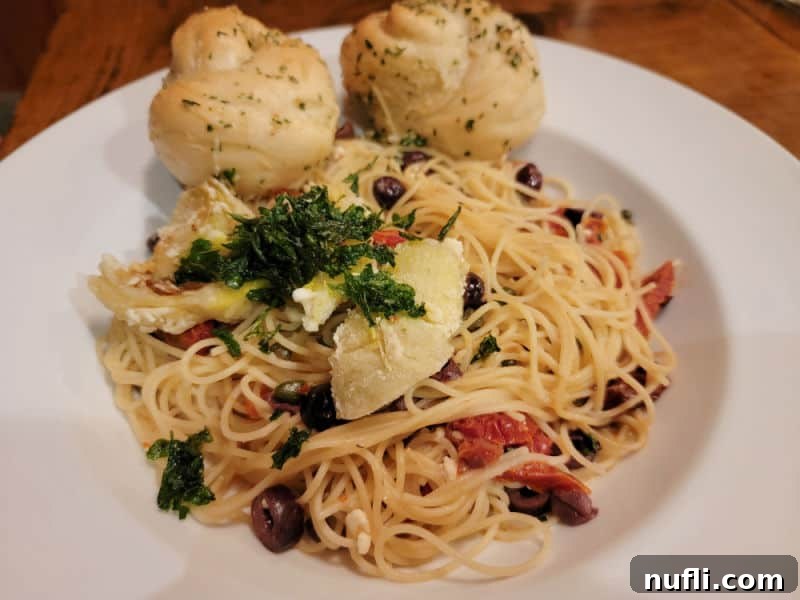 Ellensburg Unveiled: Your Washington Adventure 5 Pasta on a white plate with two rolls