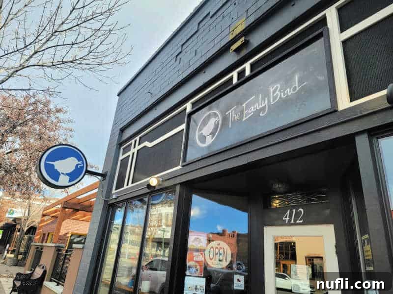 The Early bird sign over the entrance to a restaurant, small bird with a worm sign on the side