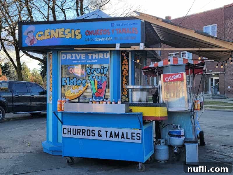 Churro and tamales stand with elotes and fruit cup on the window