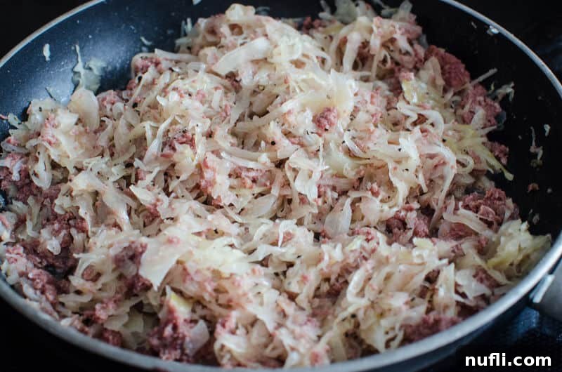 Hearty Corned Beef Shepherds Pie 5 onions and corned beef in a skillet