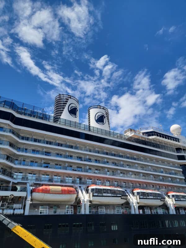 The impressive ms Eurodam cruise ship, adorned with lifeboats, ready for its journey through the Alaskan wilderness.