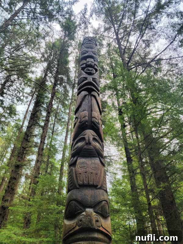 A towering totem pole intricately carved with various figurines, a striking cultural landmark in Sitka.