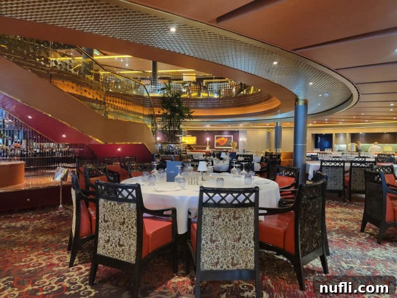 A spacious and elegant dining room area, complete with beautifully set tables and comfortable chairs, aboard the Holland America Eurodam.
