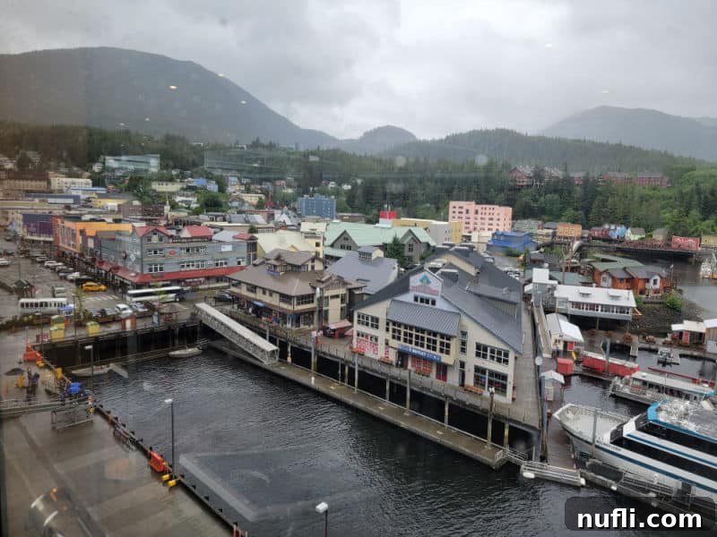 An aerial view over Ketchikan, with buildings lining the water's edge, capturing the unique architecture of this Alaskan port.