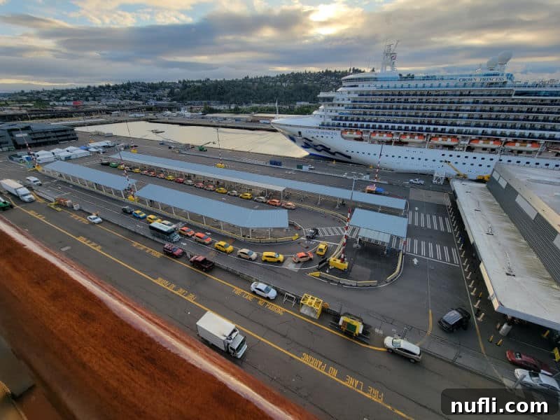 Cruise ship parking area with taxi's seen from the balcony with another cruise ship on the other side of the lot