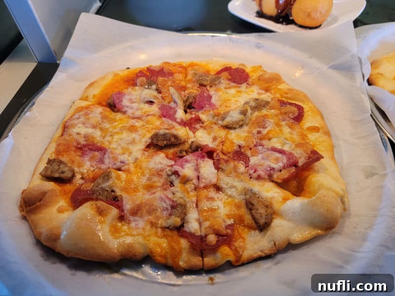 A delicious meat-topped pizza served on a tray, a perfect casual meal option aboard the Holland America Eurodam.