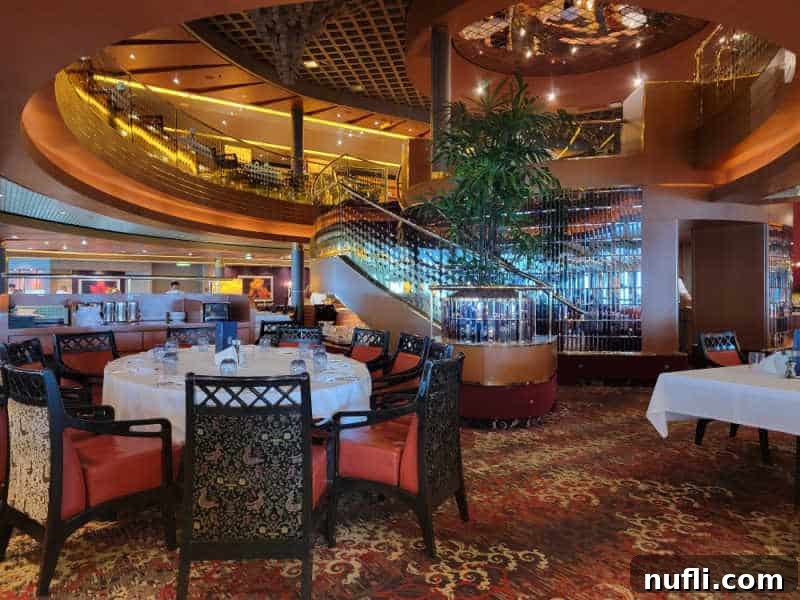 Dining room with a staircase in the middle, shiny glass and chandelier