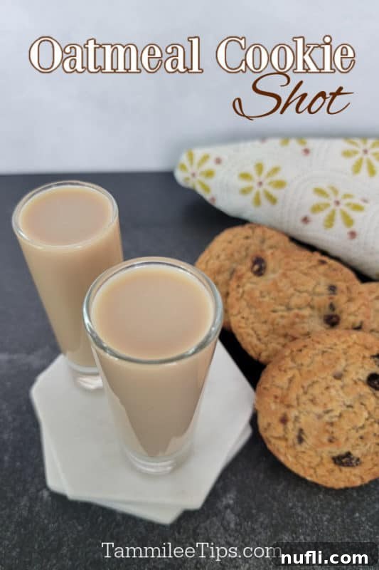 Oatmeal Cookie Milk Shots 2 Two Oatmeal Cookie Shots next to oatmeal cookies and a cloth napkin, ready to be enjoyed.