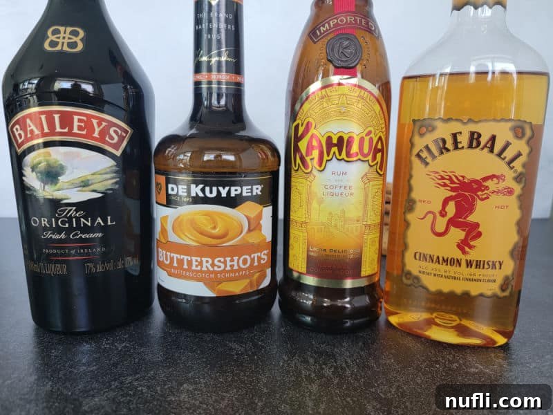 Oatmeal Cookie Milk Shots 3 Bottles of Baileys Irish Cream, Butterscotch Schnapps, Kahlua, and Fireball Cinnamon Whisky, key ingredients for the shot.