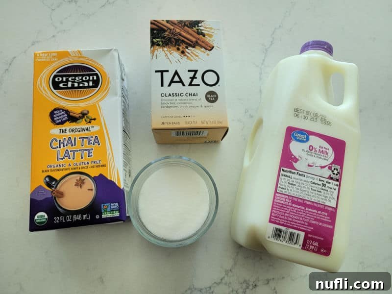 Oregon Chai Latte box, Tazo Classic Chai box, milk, and sugar on a white counter