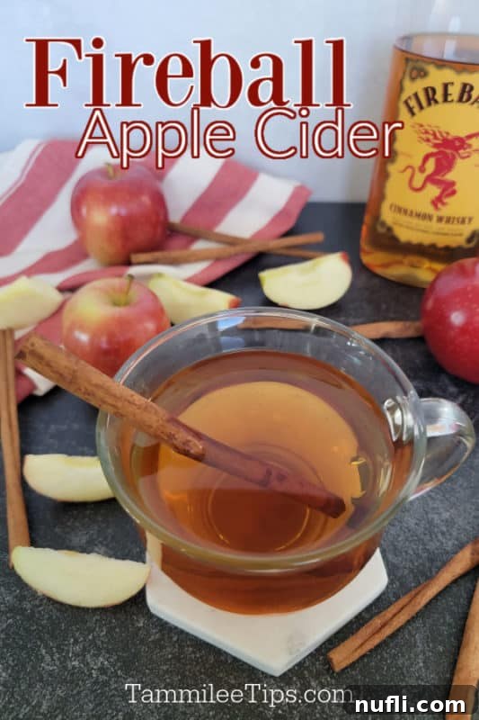 Ultimate Fireball Apple Cider 2 Fireball Apple Cider text over a glass with apple cider and a cinnamon stick next to a bottle of Fireball whisky, apples, and a red cloth napkin