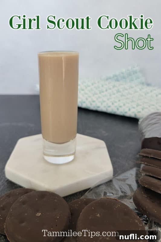 Girl Scout Shot text above a filled shot glass on a white coaster surrounded by thin mint cookies