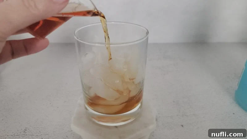 Emerald Fury Fuel 4 Hennessey Cognac pouring into a cocktail glass