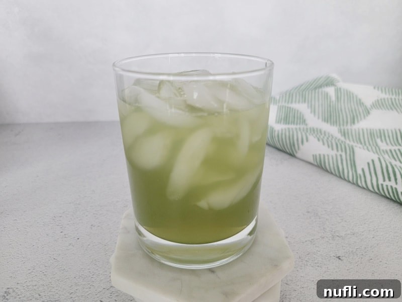 Gamma Ray Gulp 6 Green Incredible Hulk Drink in a cocktail glass next to a green cloth napkin