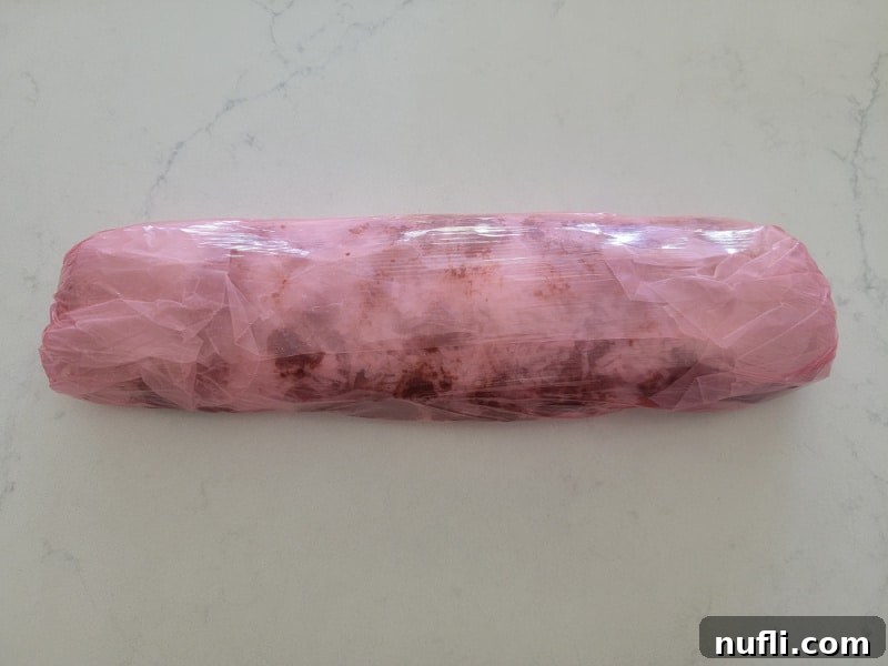 Church Window Cookies: A Visual Recipe Guide 9 Red saran wrap plastic coating wrapped around a log of no bake church window cookies