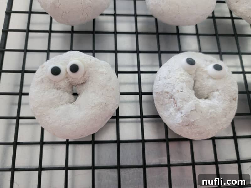 Powdered sugar donuts with candy eyes