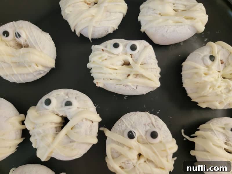 mini mummy doughnuts on a black platter