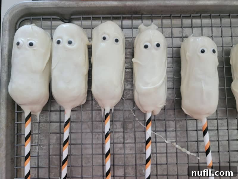 Chocolate-covered Twinkies with candy eyes, beginning to resemble spooky mummies