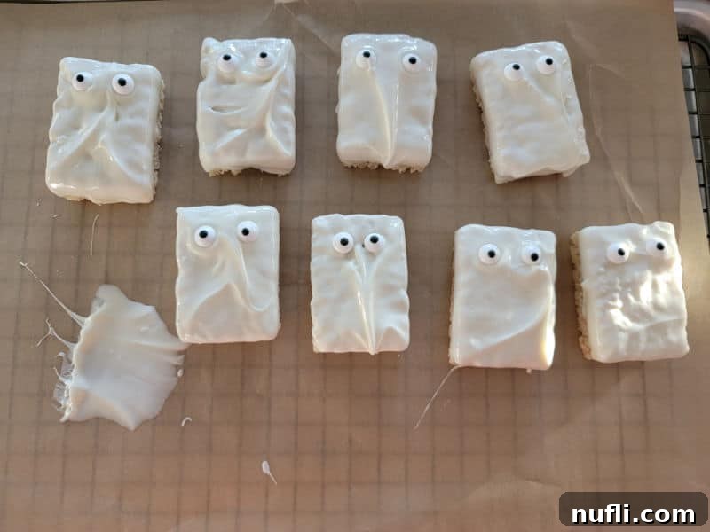 Monster Mummy Krispie Treats 5 White chocolate dipped rice krispie treats with candy eyes, demonstrating the initial decoration stage.