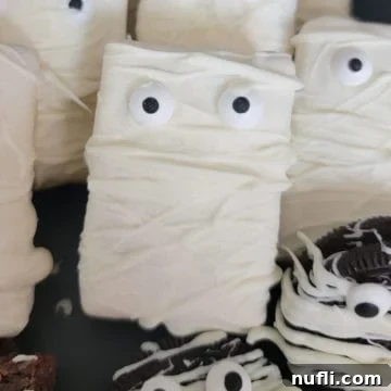 Monster Mummy Krispie Treats 8 mummy rice krispie treat on a dark platter