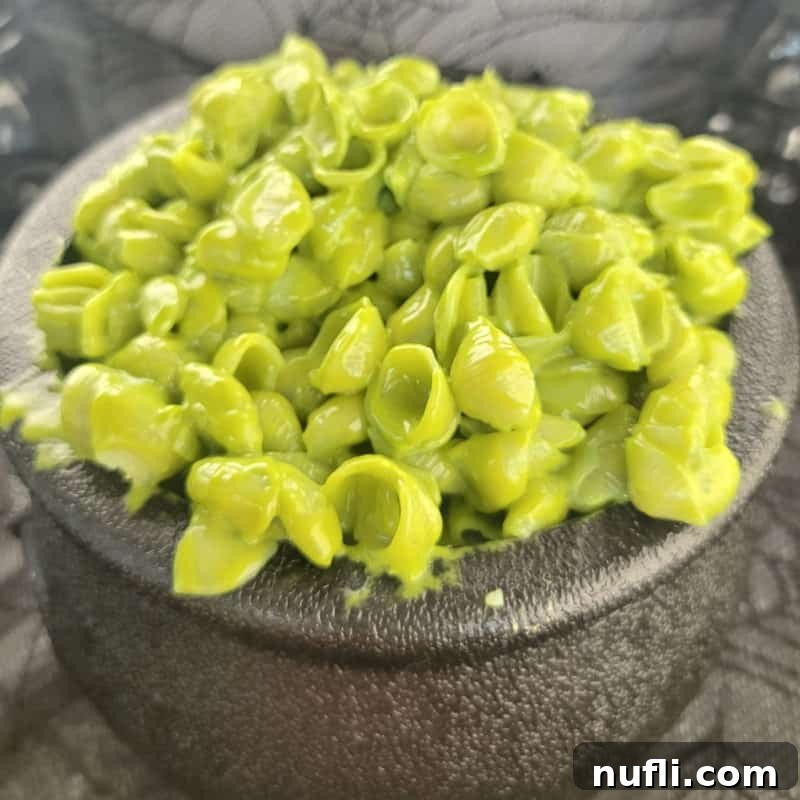Green Halloween Pasta in a a black cauldron, ready to be served