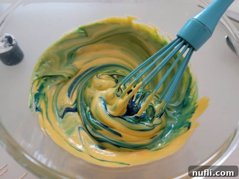Blue food coloring mixing into cheese sauce