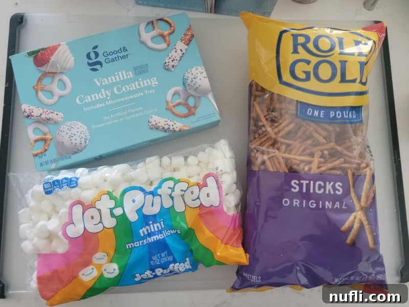 Ingredients for White Chocolate Pretzel Bones: vanilla candy coating, mini marshmallows, and pretzel sticks