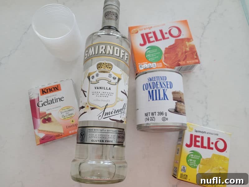 Festive Candy Corn Jello Shooters 3 Candy Corn Jello shots ingredients, gelatin, vanilla vodka, sweetened condensed milk, orange jello, and lemon jello