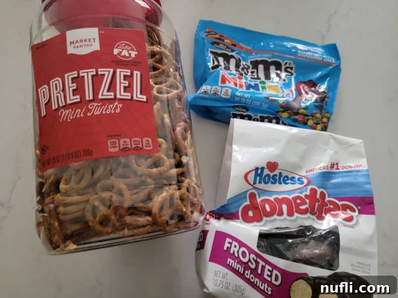 Simple ingredients for Spider Donuts: chocolate mini donuts, pretzels, and candy eyes