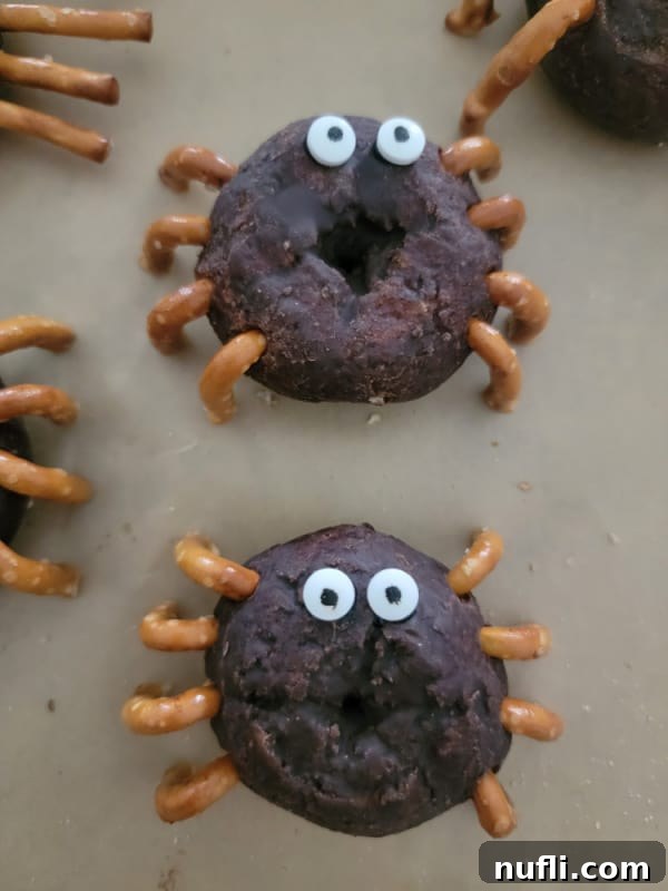 A cluster of spider donettes resting on parchment paper, ready to be served