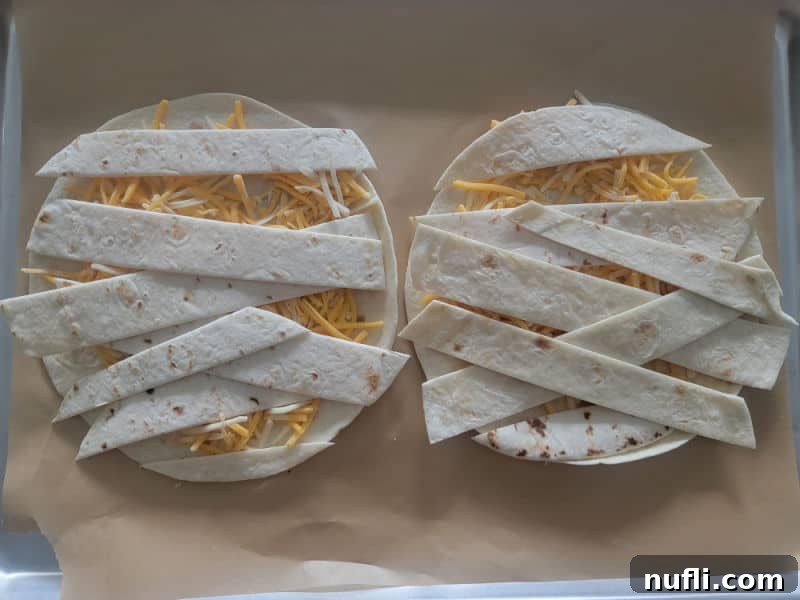 criss cross quesadilla on parchment paper for mummy quesadillas 
