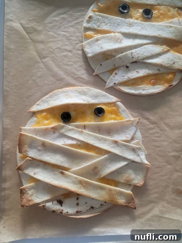 Mummy quesadillas on parchment paper