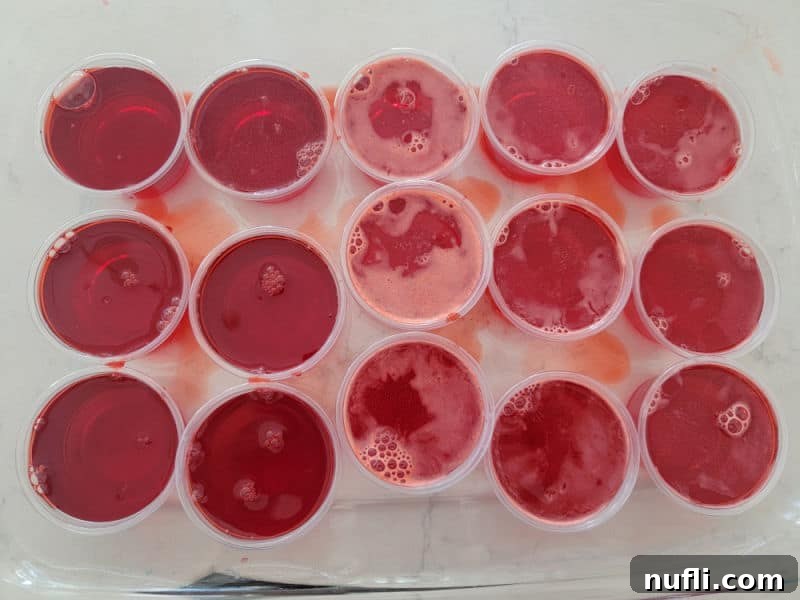 Inferno Jiggle Shots 6 Red fireball jello shots in plastic cups in a casserole dish