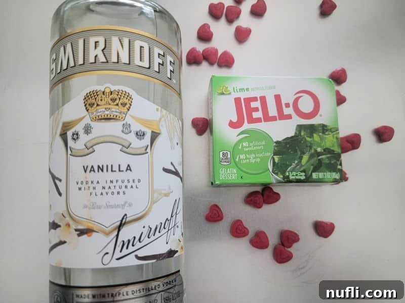 Deliciously Easy Festive Grinch Jello Shots 3 Key ingredients for Grinch Jell-O Shots: Vanilla Vodka, Green Lime Jell-o mix, and red heart candies for garnish