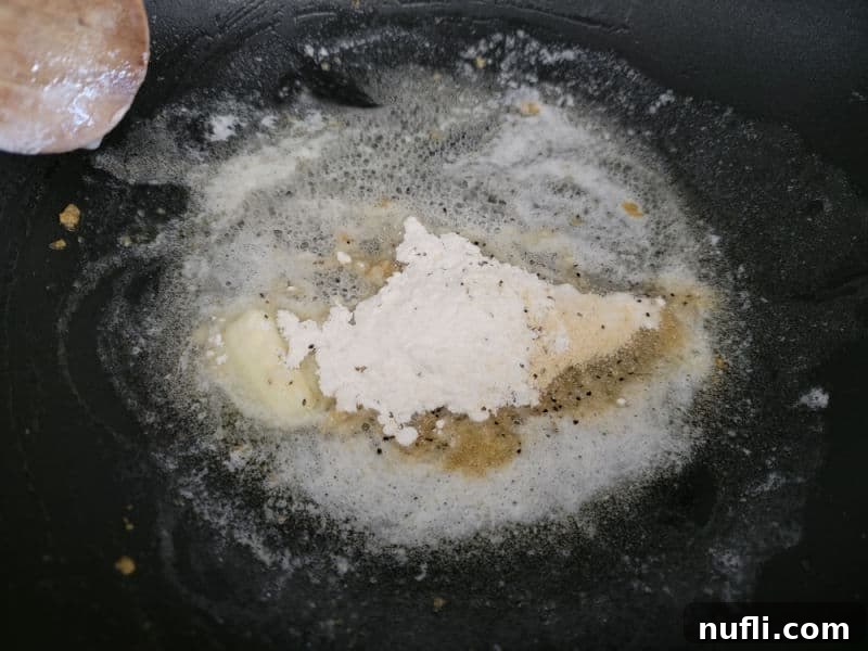 Flour and seasonings bubbling in melted butter, forming the base of the cheesy green beans sauce.