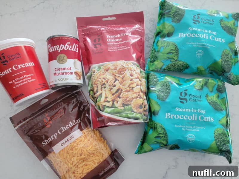 Effortlessly Delicious Broccoli Bake 3 Broccoli Casserole Recipe ingredients sour cream, cream of mushroom soup, french fried onions, frozen broccoli florets, and sharp cheddar cheese