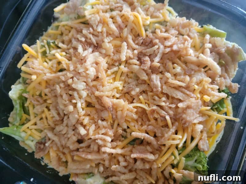 Effortlessly Delicious Broccoli Bake 8 Cheddar cheese and French fried onions spread on broccoli casserole