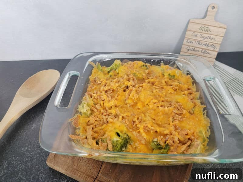 Effortlessly Delicious Broccoli Bake 9 Cheesy Broccoli Casserole Recipe next to a wooden spoon
