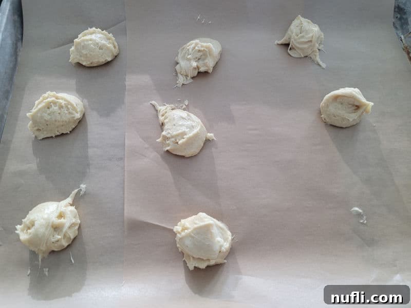 eggnog cookie dough on a parchment lined baking sheet before baking