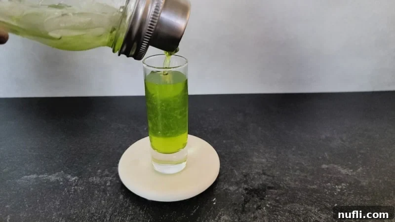 Pouring Broken Down Golf Cart Shot into a cocktail shooter glass