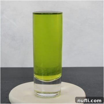 Broken Down Golf Cart green shot in a glass on a coaster