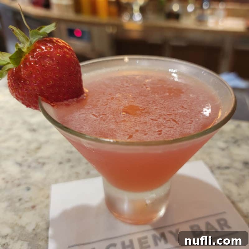 The Ultimate Guide to Peach Schnapps Cocktails 7 Alchemy Bar Curative Peach Cosmopolitan cocktail on a white napkin